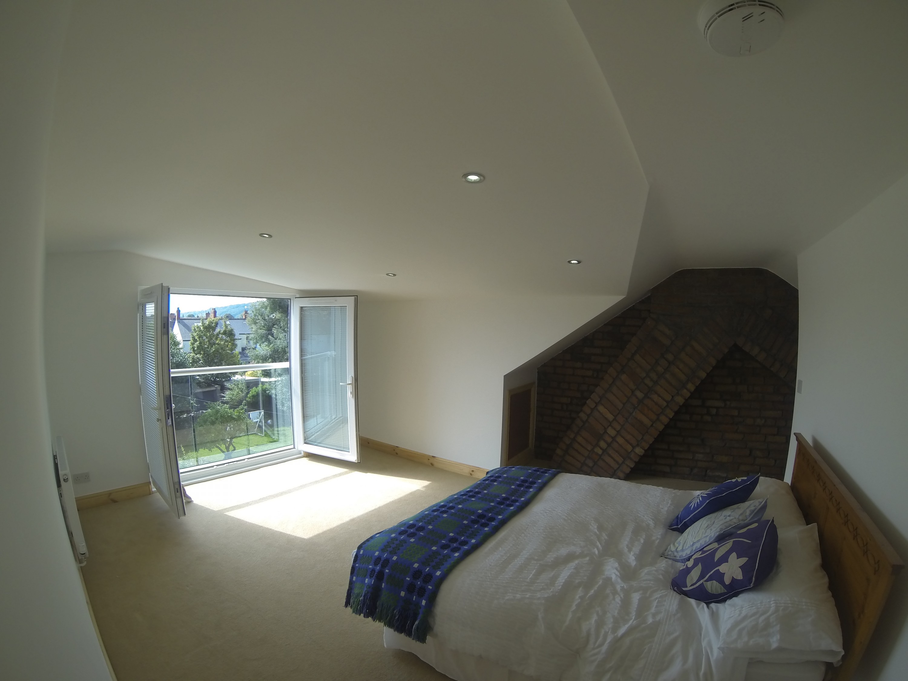 Master bedroom with exposed chimney 